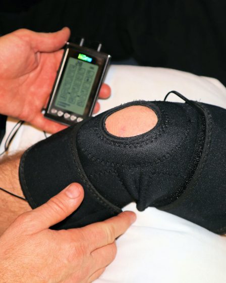 person holding black knit cap