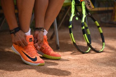 person wearing orange nike sneakers